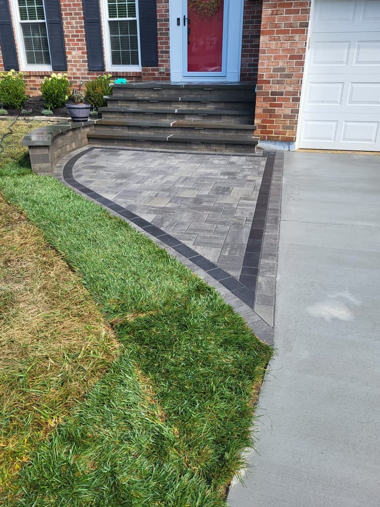 Detail of the paver apron and its charcoal border against the new lawn edge
