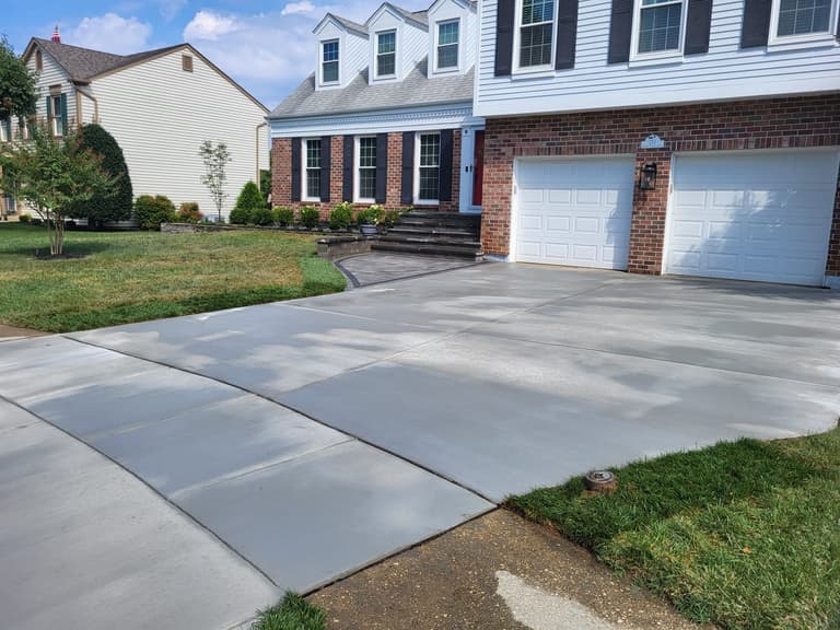 The driveway sweeping up to the two-car garage