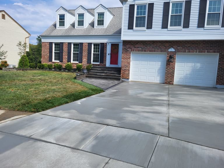 The finished driveway, landing, and front entry seen from the street