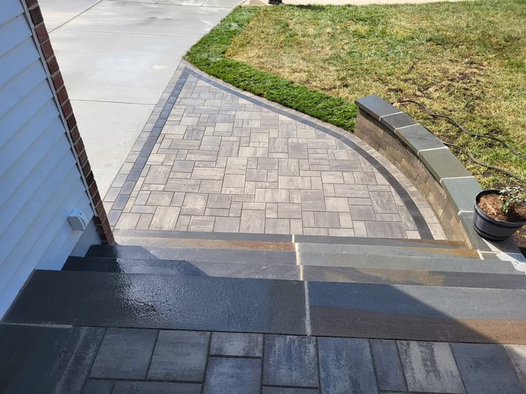 The paver landing meeting the driveway, with the soldier-course border tying the two together