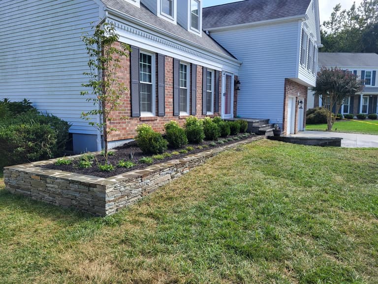 The bluestone treads and paver risers stepping up from the landing to the front door