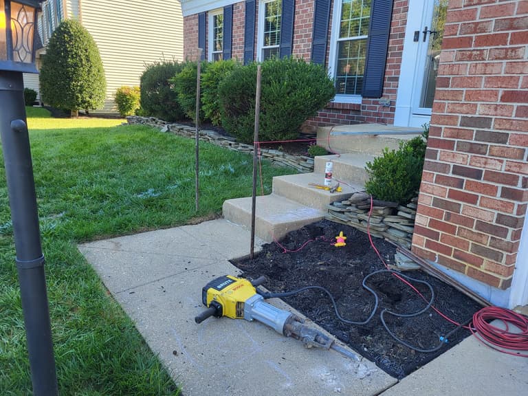 Demolition — the front planting bed excavated and marked out alongside the original walk