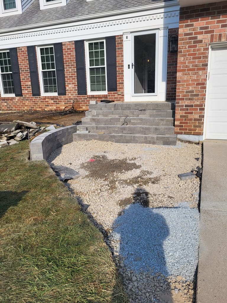 During — compacted stone base laid where the old stoop had been, with the first course of block set