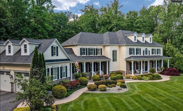 Foundation plantings and a striped lawn at a colonial home