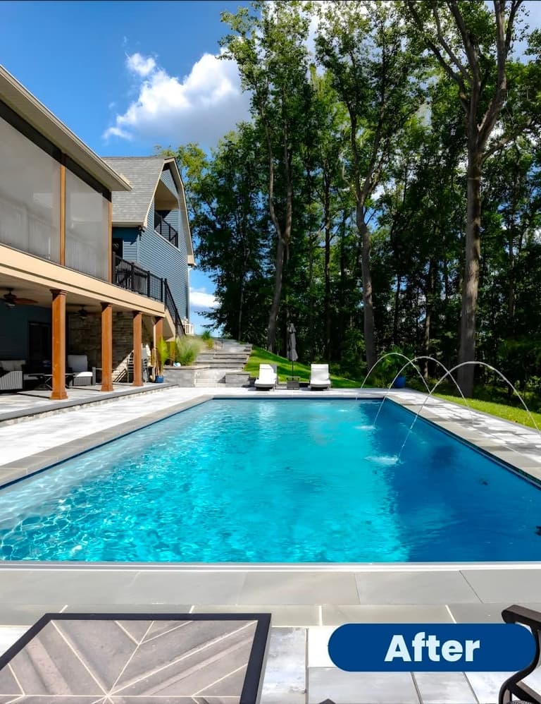 Modern rectangular pool with deck jets and a paver surround