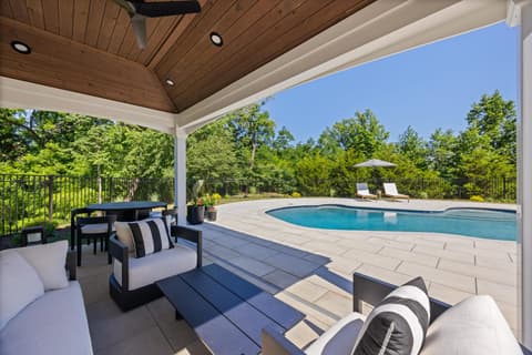 Outdoor lounge seating beneath the pavilion