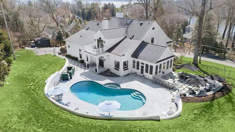 Aerial view of the pool, patio, and backyard