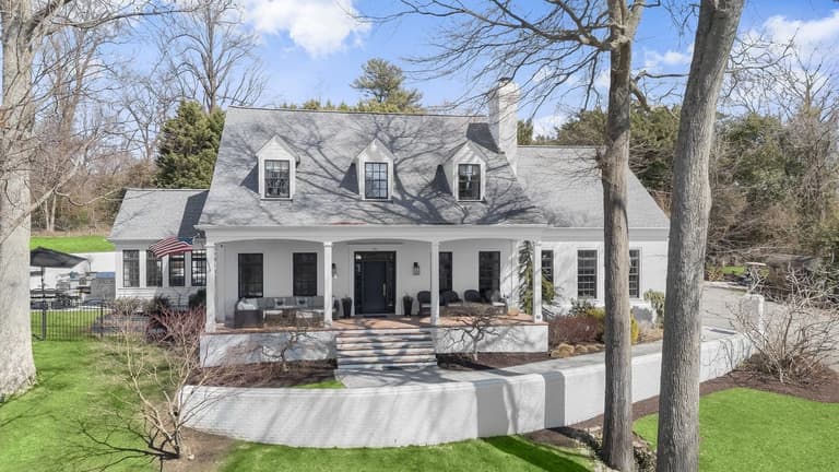 Aerial view of the front elevation, marble walkway, and curved brick retaining wall