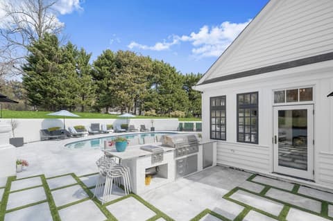 Built-in outdoor kitchen beside the pool and patio